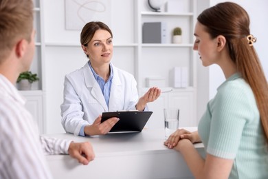 Photo of In vitro fertilization (IVF). Couple having appointment with doctor in reproductive clinic