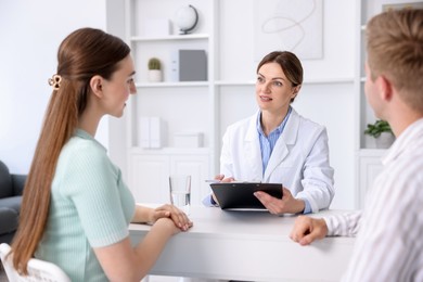 Photo of In vitro fertilization (IVF). Couple having appointment with doctor in reproductive clinic