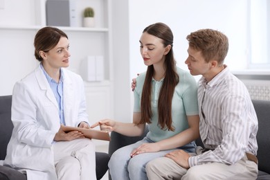 Photo of In vitro fertilization (IVF). Couple having appointment with doctor in reproductive clinic