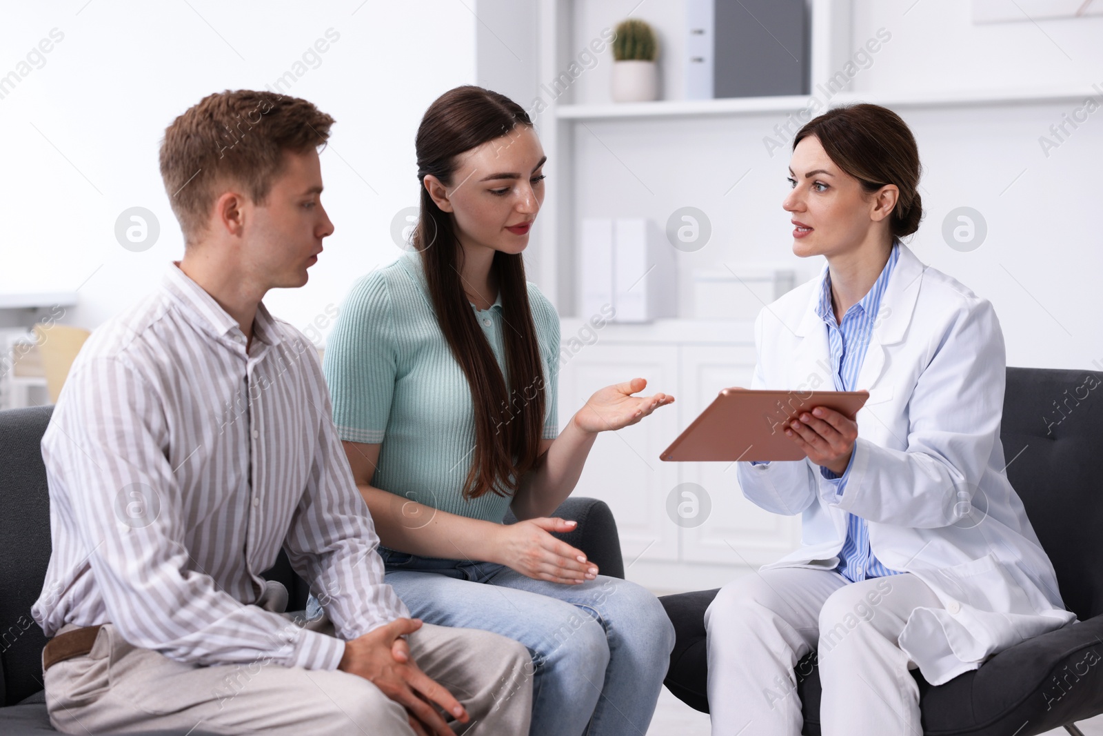 Photo of In vitro fertilization (IVF). Couple having appointment with doctor in reproductive clinic
