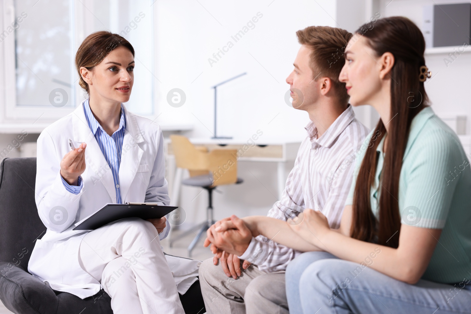 Photo of In vitro fertilization (IVF). Couple having appointment with doctor in reproductive clinic