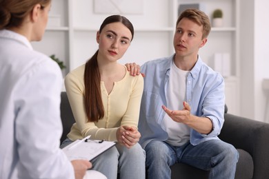 Photo of In vitro fertilization (IVF). Couple having appointment with doctor in reproductive clinic