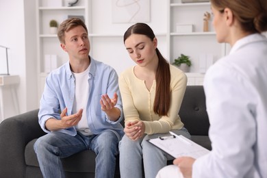 Photo of In vitro fertilization (IVF). Couple having appointment with doctor in reproductive clinic