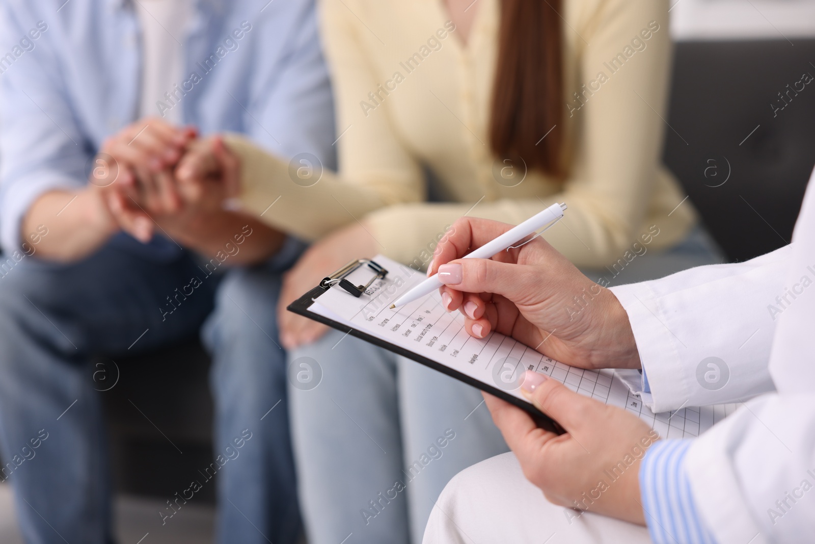 Photo of In vitro fertilization (IVF). Couple having appointment with doctor in reproductive clinic, closeup