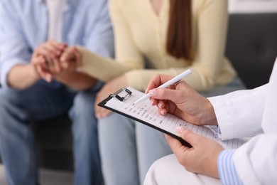 Photo of In vitro fertilization (IVF). Couple having appointment with doctor in reproductive clinic, closeup
