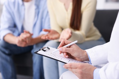 Photo of In vitro fertilization (IVF). Couple having appointment with doctor in reproductive clinic, closeup