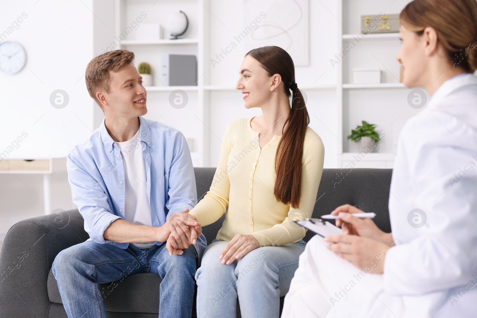 In vitro fertilization (IVF). Couple holding hands during appointment with doctor in reproductive clinic Photo of In vitro fertilization (IVF). Couple holding hands during appointment with doctor in reproductive clinic