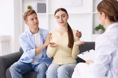 Photo of In vitro fertilization (IVF). Couple having appointment with doctor in reproductive clinic