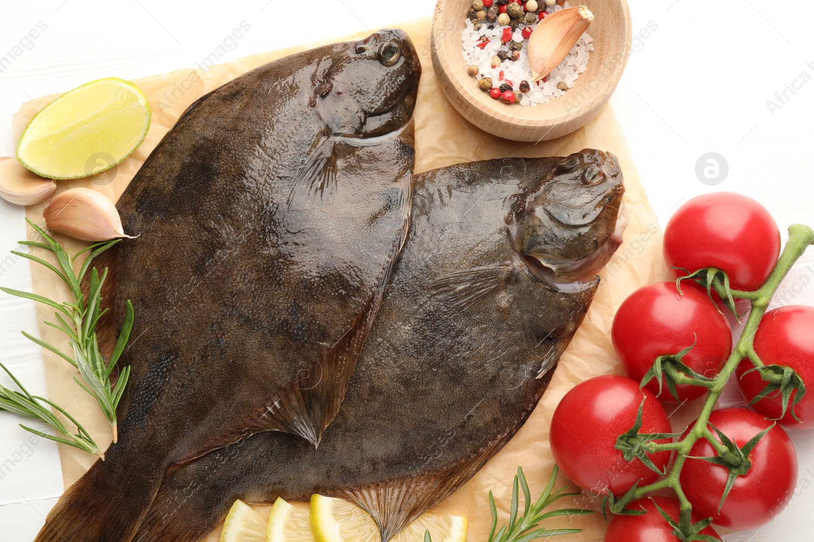 Fresh raw flounder fish and ingredients on white wooden table, flat lay. Seafood Photo of Fresh raw flounder fish and ingredients on white wooden table, flat lay. Seafood