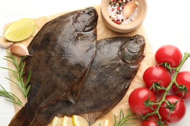 Photo of Fresh raw flounder fish and ingredients on white wooden table, flat lay. Seafood