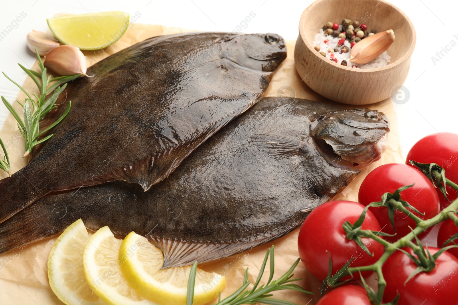 Fresh raw flounder fish and ingredients on white table, above view. Seafood Photo of Fresh raw flounder fish and ingredients on white table, above view. Seafood