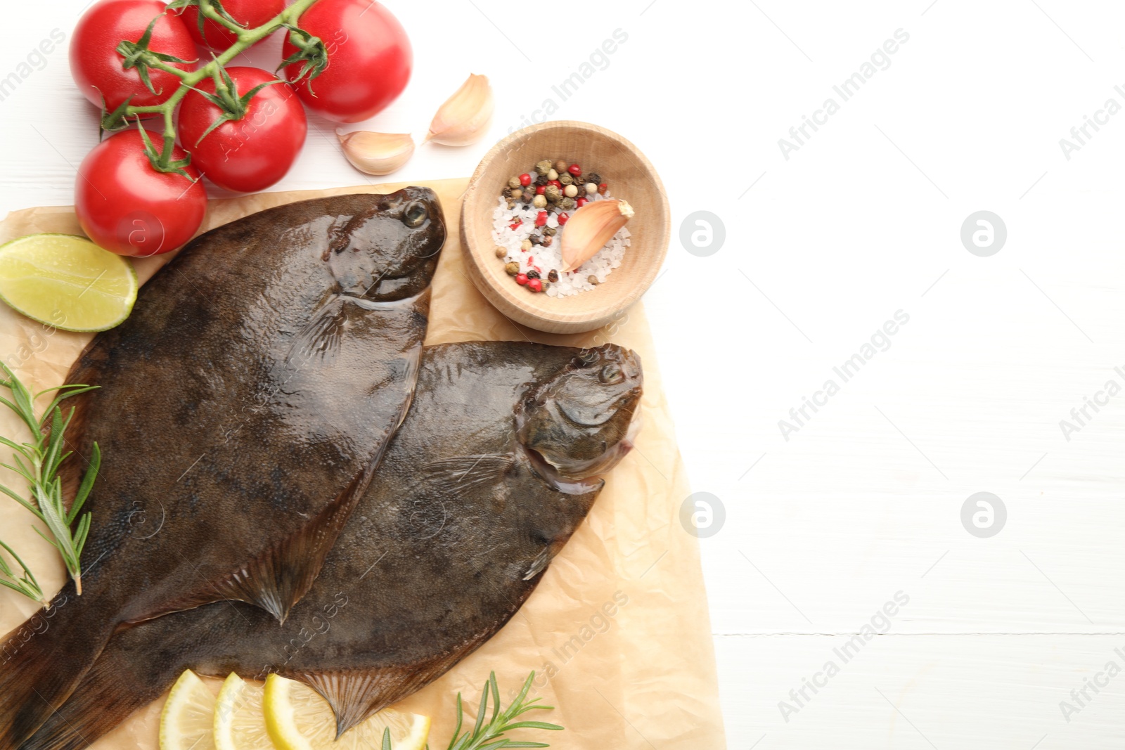 Seafood. Fresh raw flounder fish and ingredients on white wooden table, flat lay. Space for text Photo of Seafood. Fresh raw flounder fish and ingredients on white wooden table, flat lay. Space for text