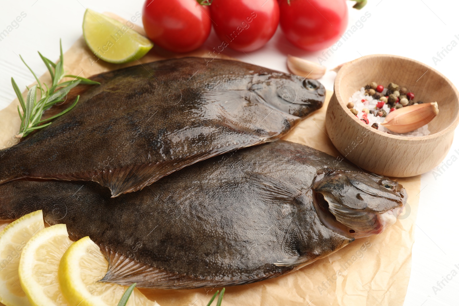 Fresh raw flounder fish and ingredients on white table, above view. Seafood Photo of Fresh raw flounder fish and ingredients on white table, above view. Seafood