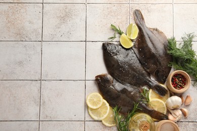 Photo of Seafood. Fresh raw flounder fish and spices on light tiled table, flat lay. Space for text