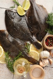 Photo of Fresh raw flounder fish and spices on light tiled table, flat lay. Seafood