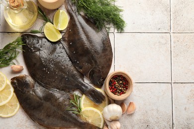 Photo of Seafood. Fresh raw flounder fish and spices on light tiled table, flat lay. Space for text