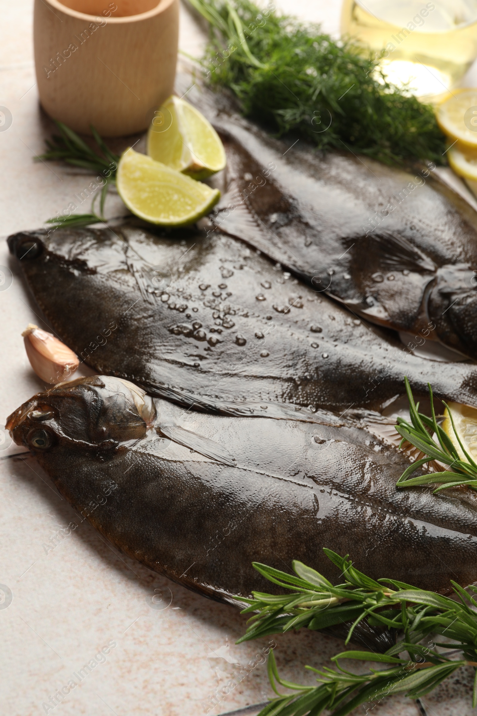 Photo of Fresh raw flounder fish and spices on light table, closeup. Seafood