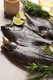 Photo of Fresh raw flounder fish and spices on light table, closeup. Seafood