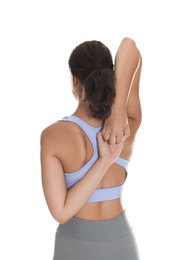 Photo of Teenage girl in sportswear stretching on white background, back view