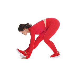 Photo of Teenage girl in sportswear stretching on white background