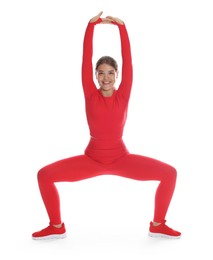 Photo of Teenage girl in sportswear stretching on white background