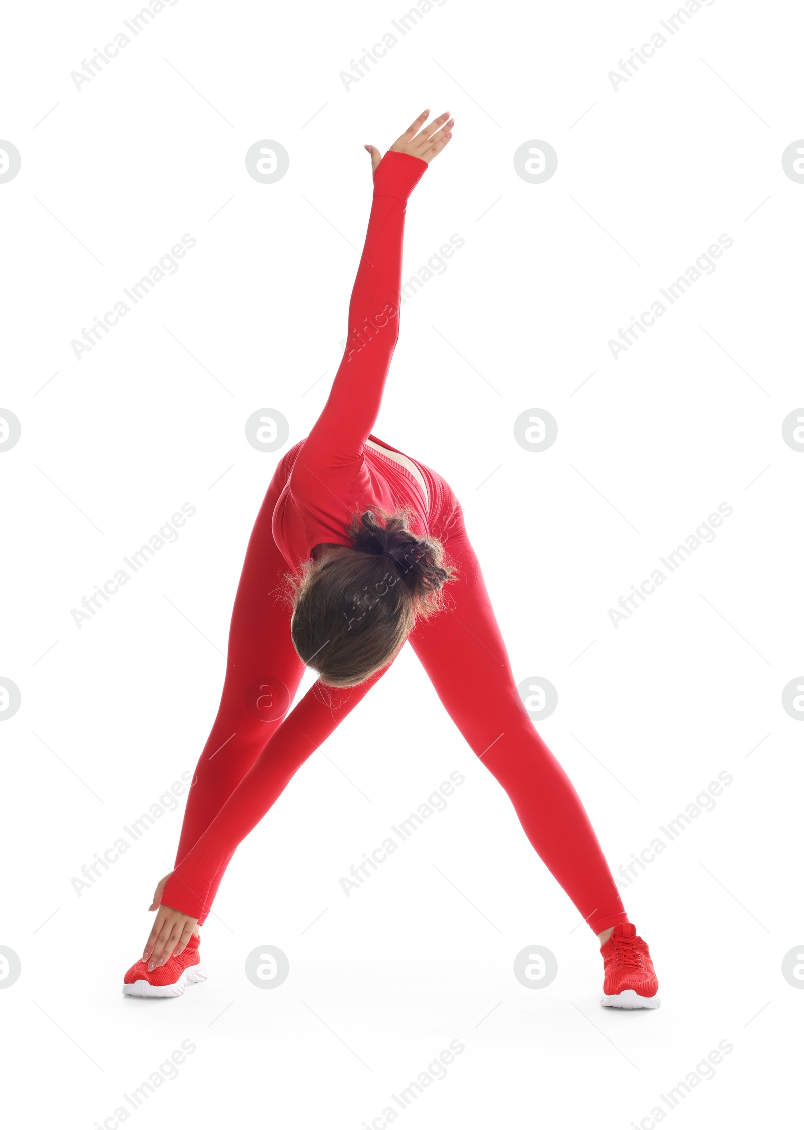 Teenage girl in sportswear stretching on white background Photo of Teenage girl in sportswear stretching on white background