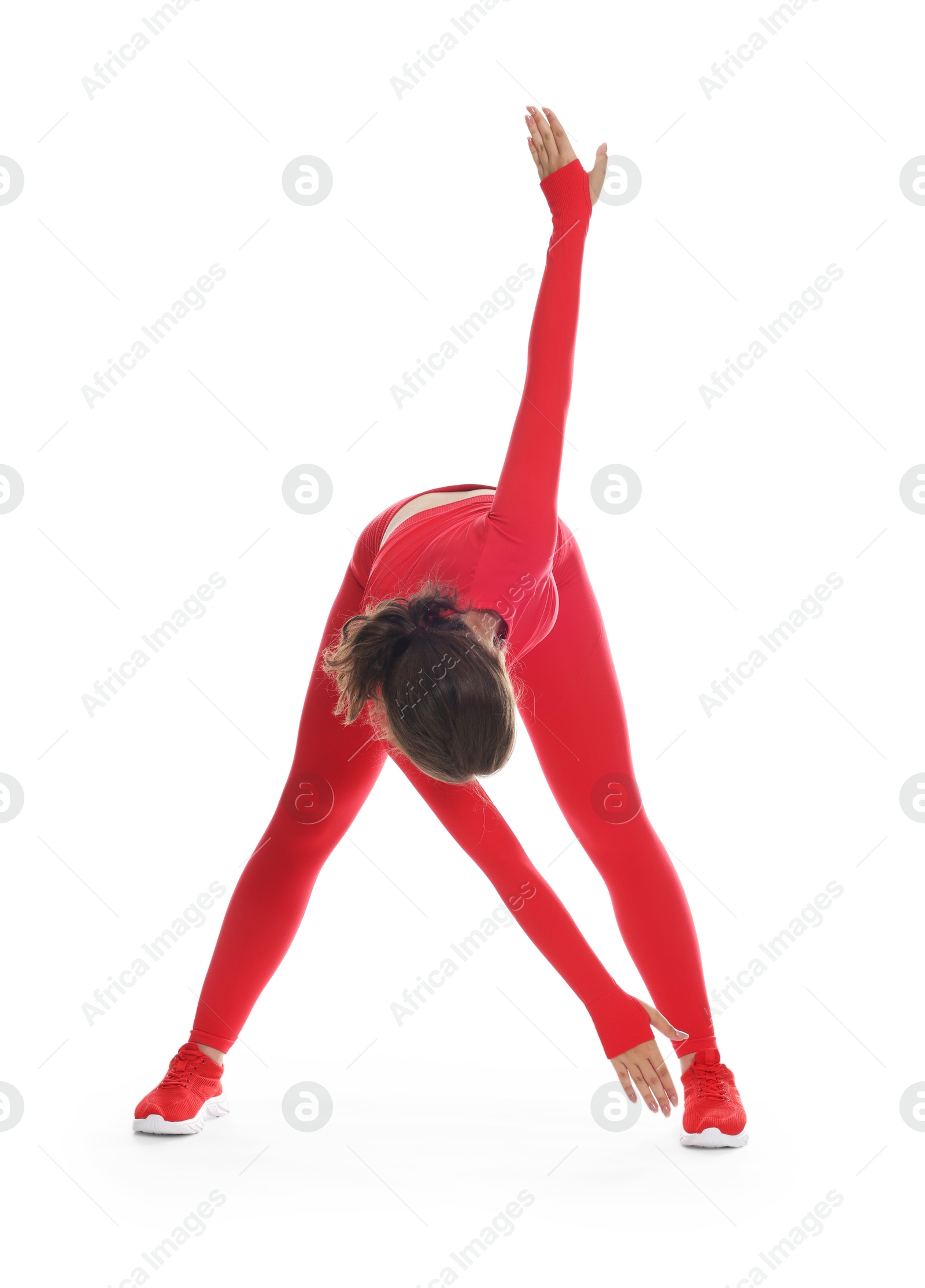 Teenage girl in sportswear stretching on white background Photo of Teenage girl in sportswear stretching on white background