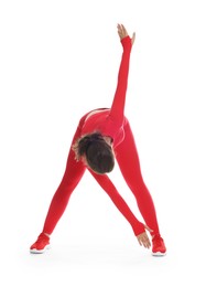 Photo of Teenage girl in sportswear stretching on white background