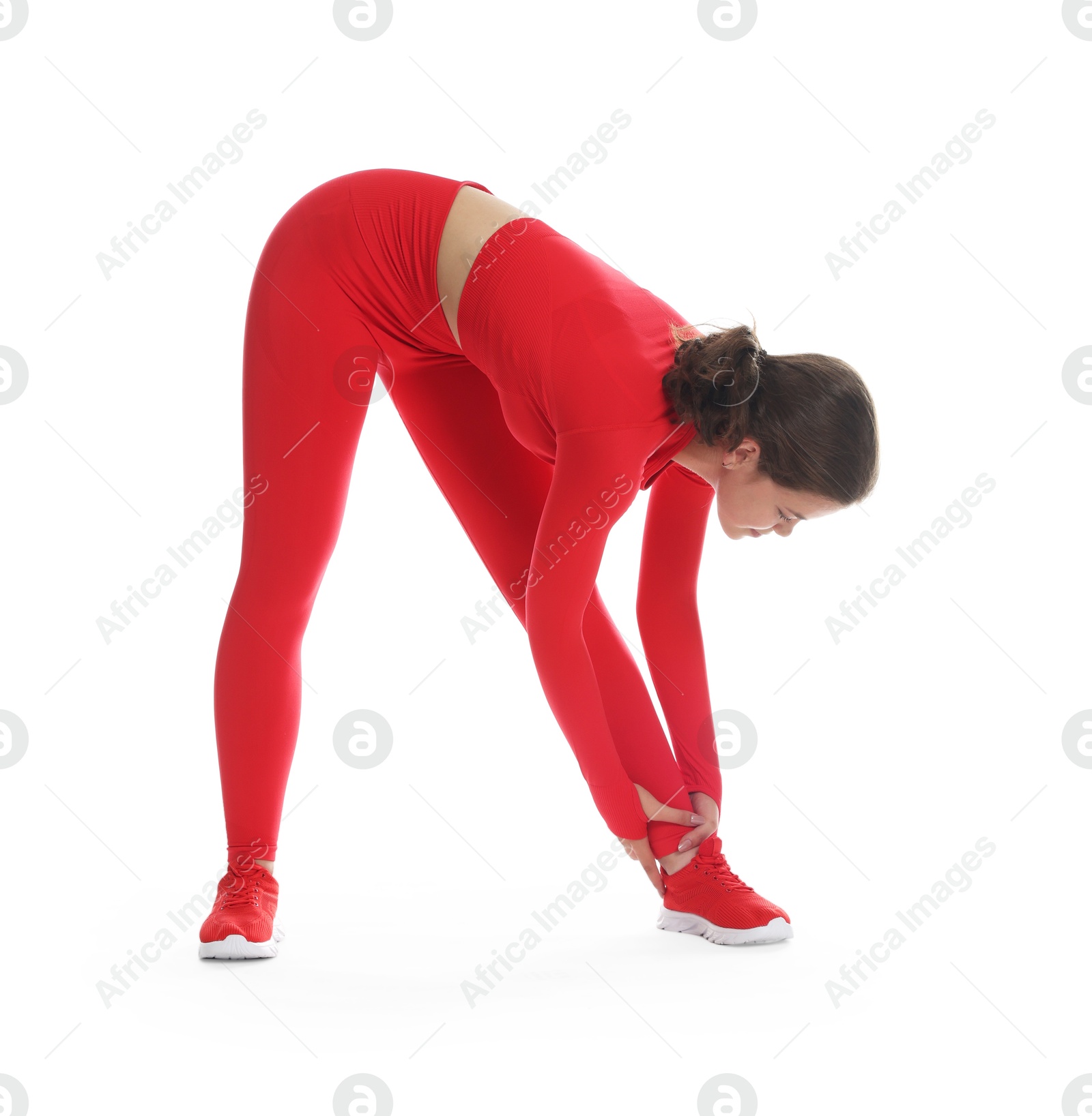 Teenage girl in sportswear stretching on white background Photo of Teenage girl in sportswear stretching on white background