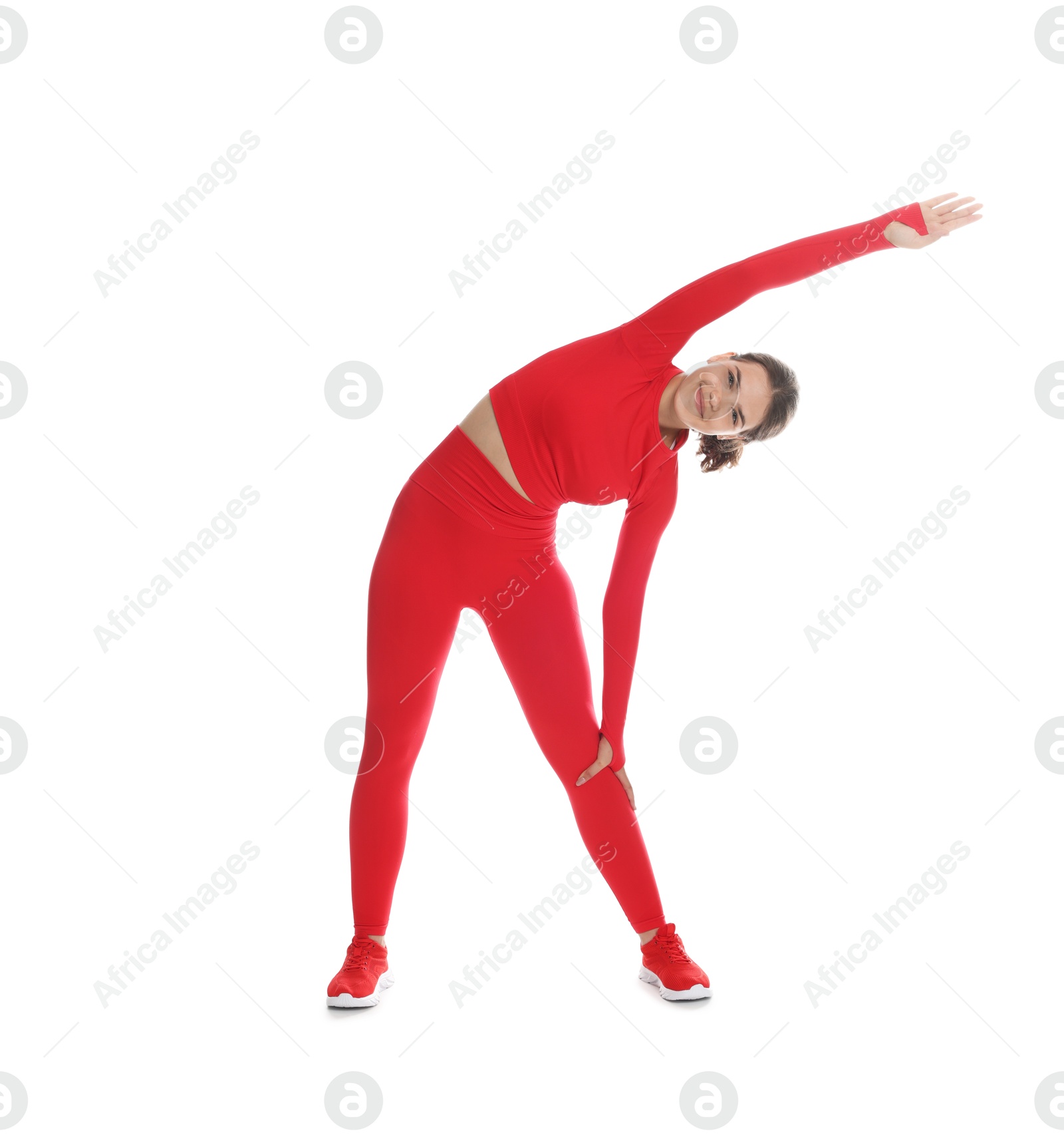 Teenage girl in sportswear stretching on white background Photo of Teenage girl in sportswear stretching on white background