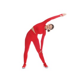 Photo of Teenage girl in sportswear stretching on white background