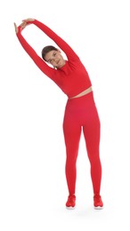 Photo of Teenage girl in sportswear stretching on white background