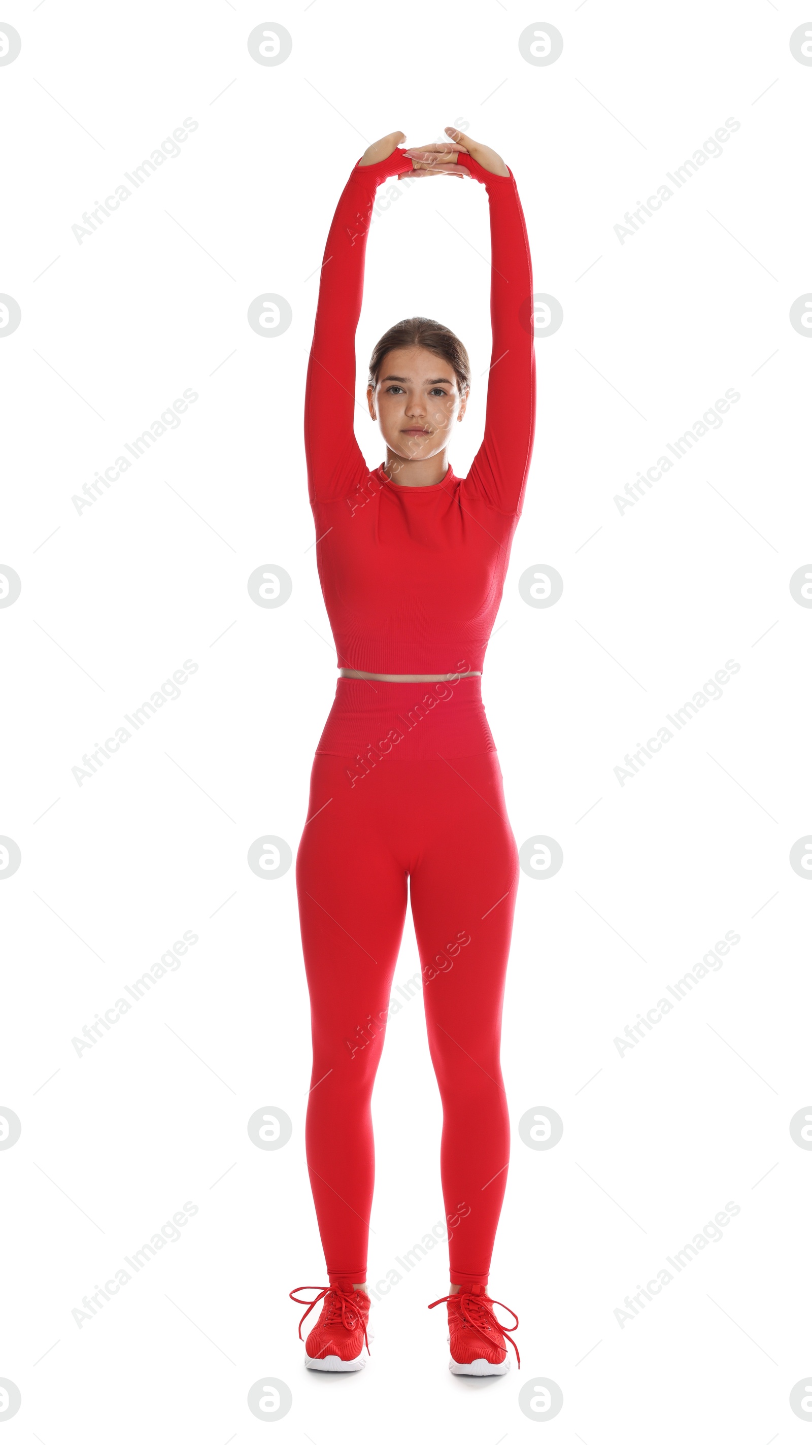 Teenage girl in sportswear stretching on white background Photo of Teenage girl in sportswear stretching on white background