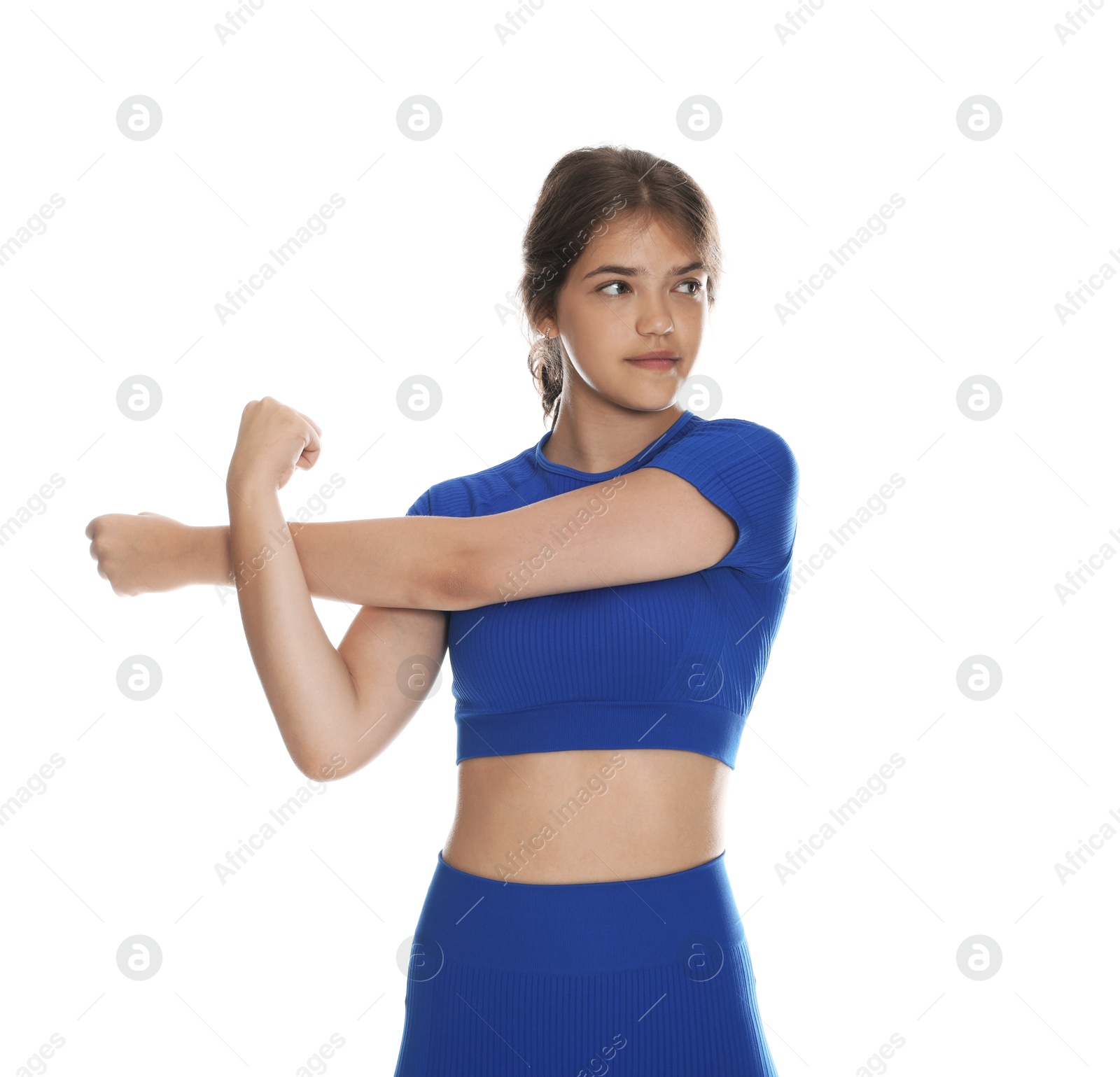 Teenage girl in sportswear stretching on white background Photo of Teenage girl in sportswear stretching on white background