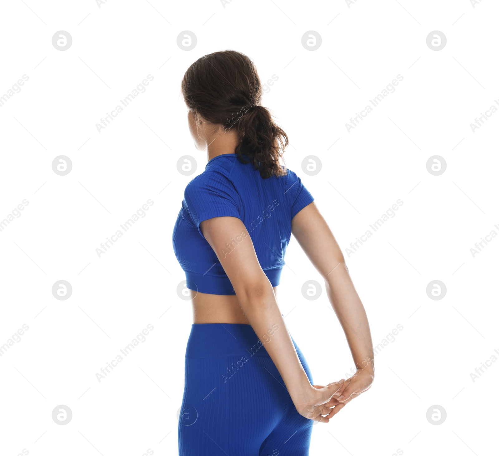 Teenage girl in sportswear stretching on white background Photo of Teenage girl in sportswear stretching on white background