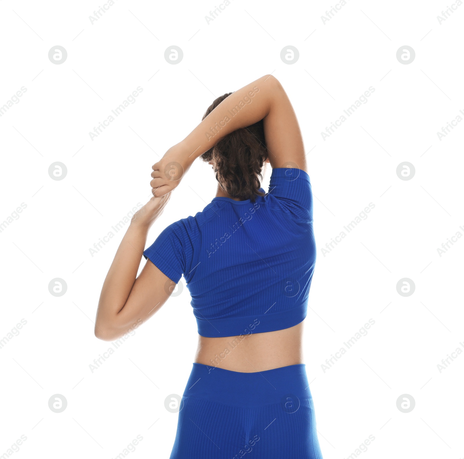 Teenage girl in sportswear stretching on white background, back view Photo of Teenage girl in sportswear stretching on white background, back view