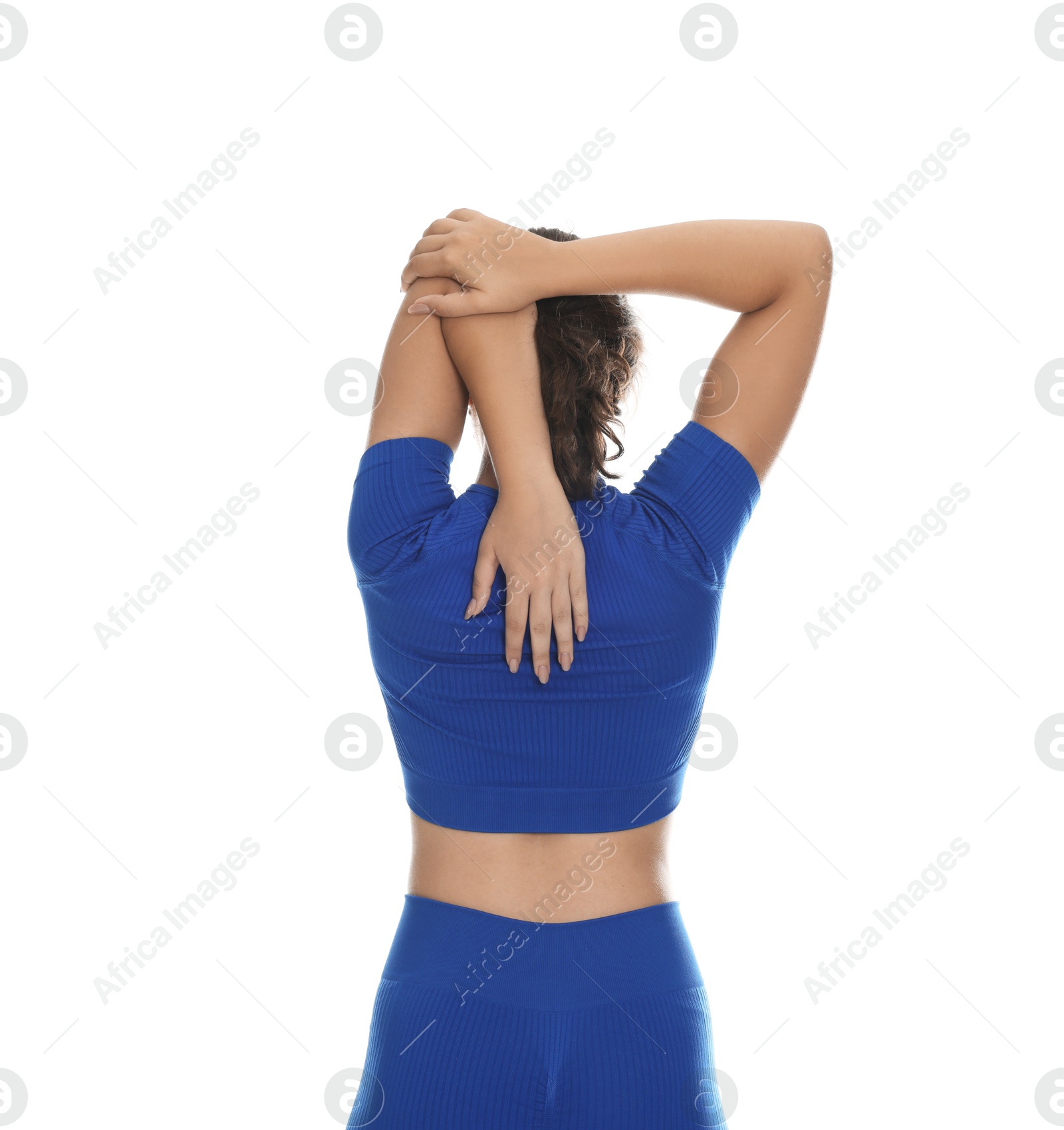 Teenage girl in sportswear stretching on white background, back view Photo of Teenage girl in sportswear stretching on white background, back view