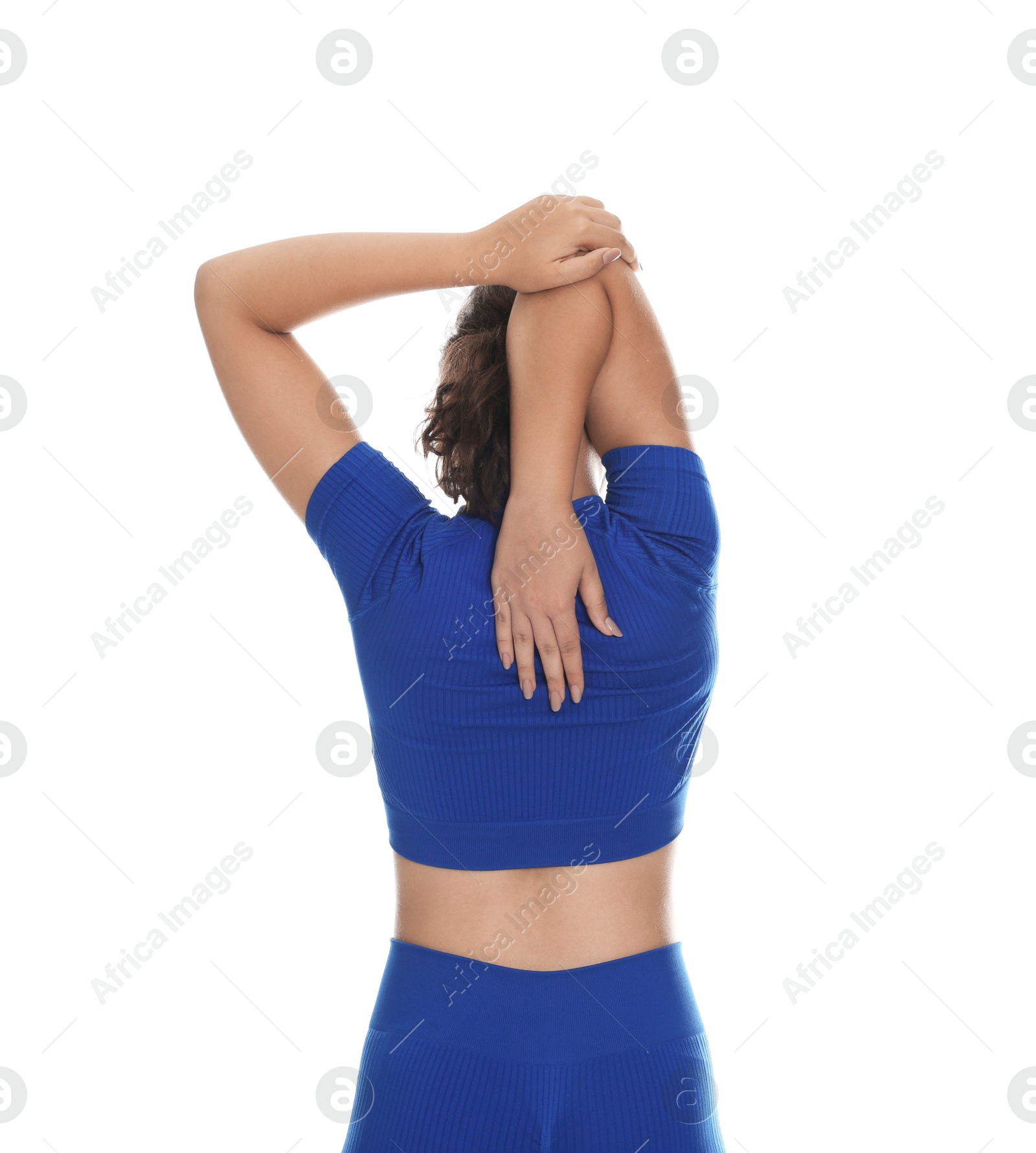 Teenage girl in sportswear stretching on white background, back view Photo of Teenage girl in sportswear stretching on white background, back view