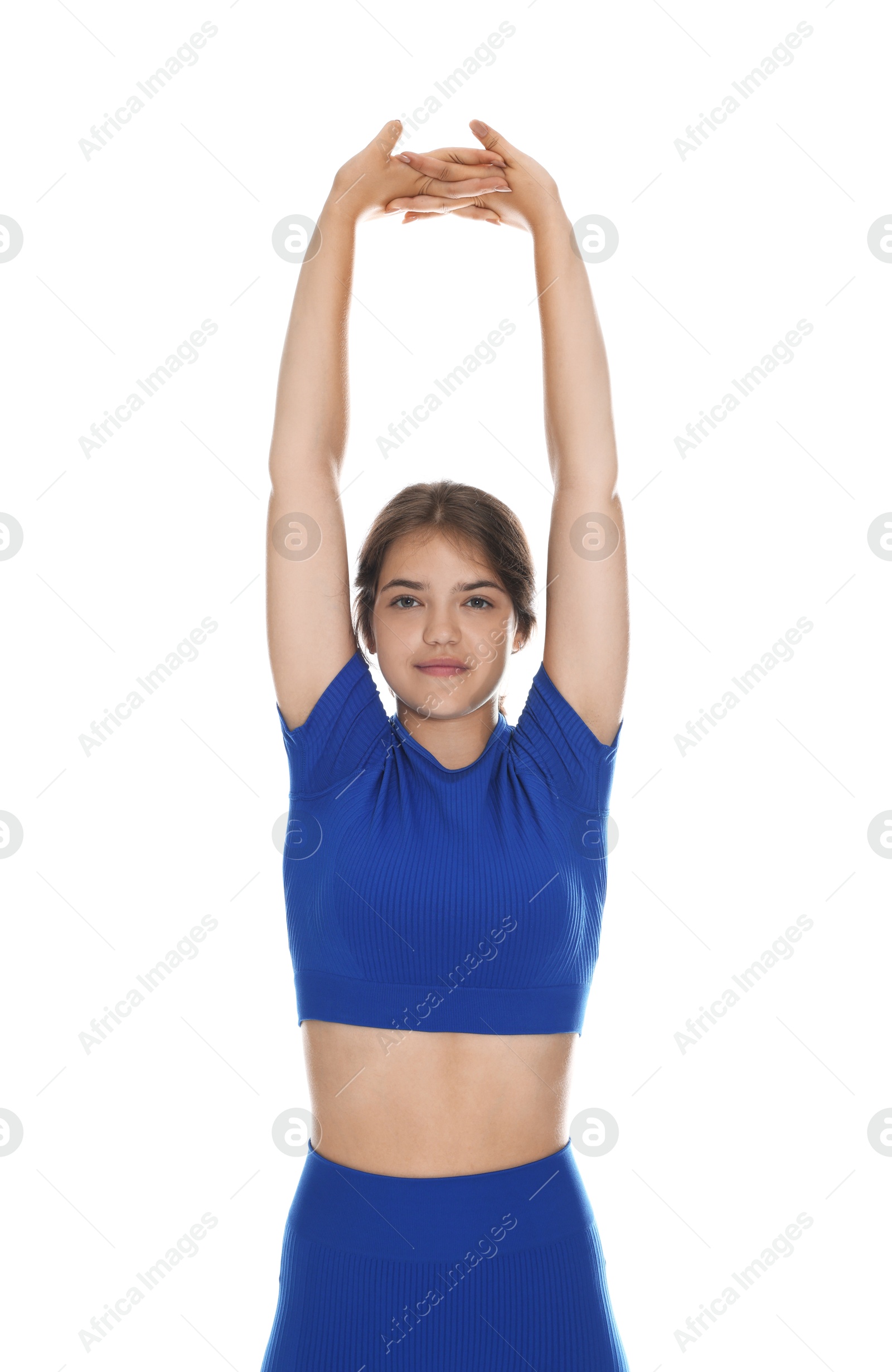 Teenage girl in sportswear stretching on white background Photo of Teenage girl in sportswear stretching on white background