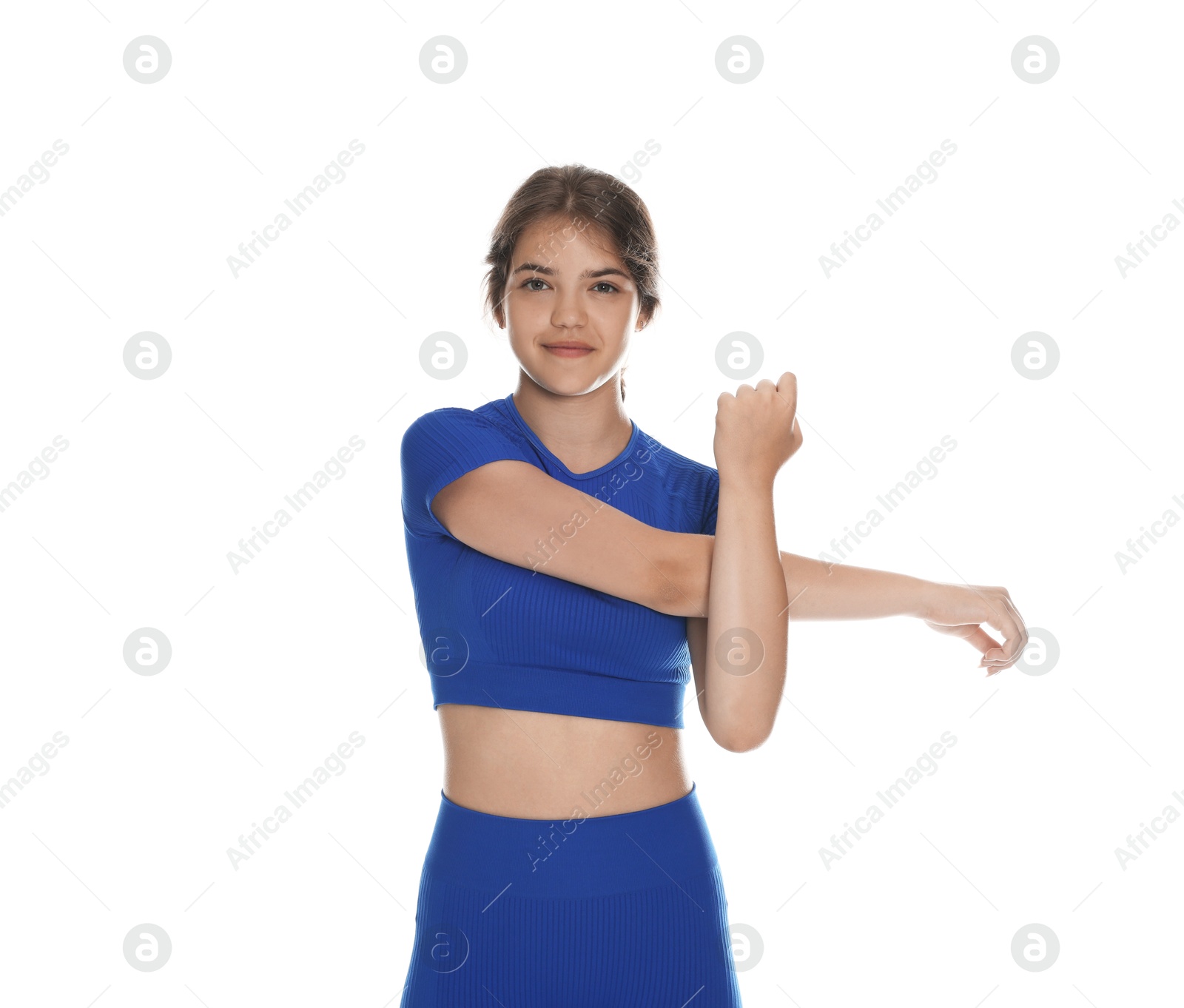 Teenage girl in sportswear stretching on white background Photo of Teenage girl in sportswear stretching on white background