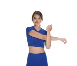 Photo of Teenage girl in sportswear stretching on white background
