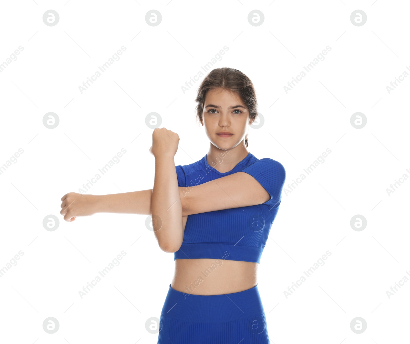 Teenage girl in sportswear stretching on white background Photo of Teenage girl in sportswear stretching on white background
