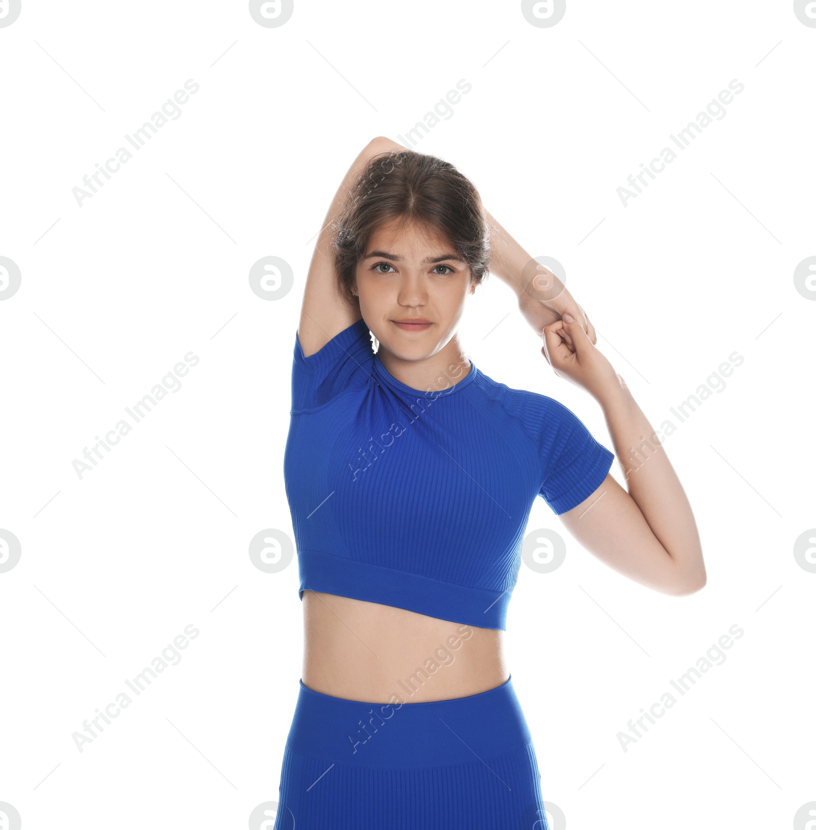 Teenage girl in sportswear stretching on white background Photo of Teenage girl in sportswear stretching on white background