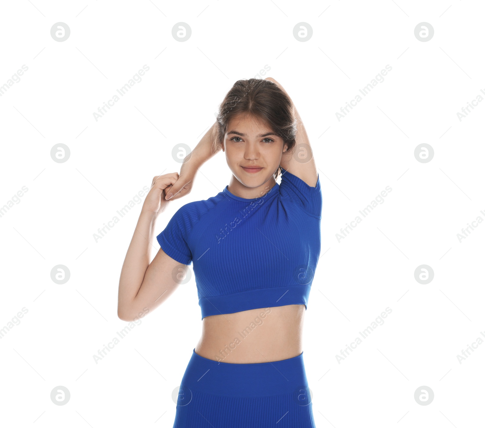 Teenage girl in sportswear stretching on white background Photo of Teenage girl in sportswear stretching on white background