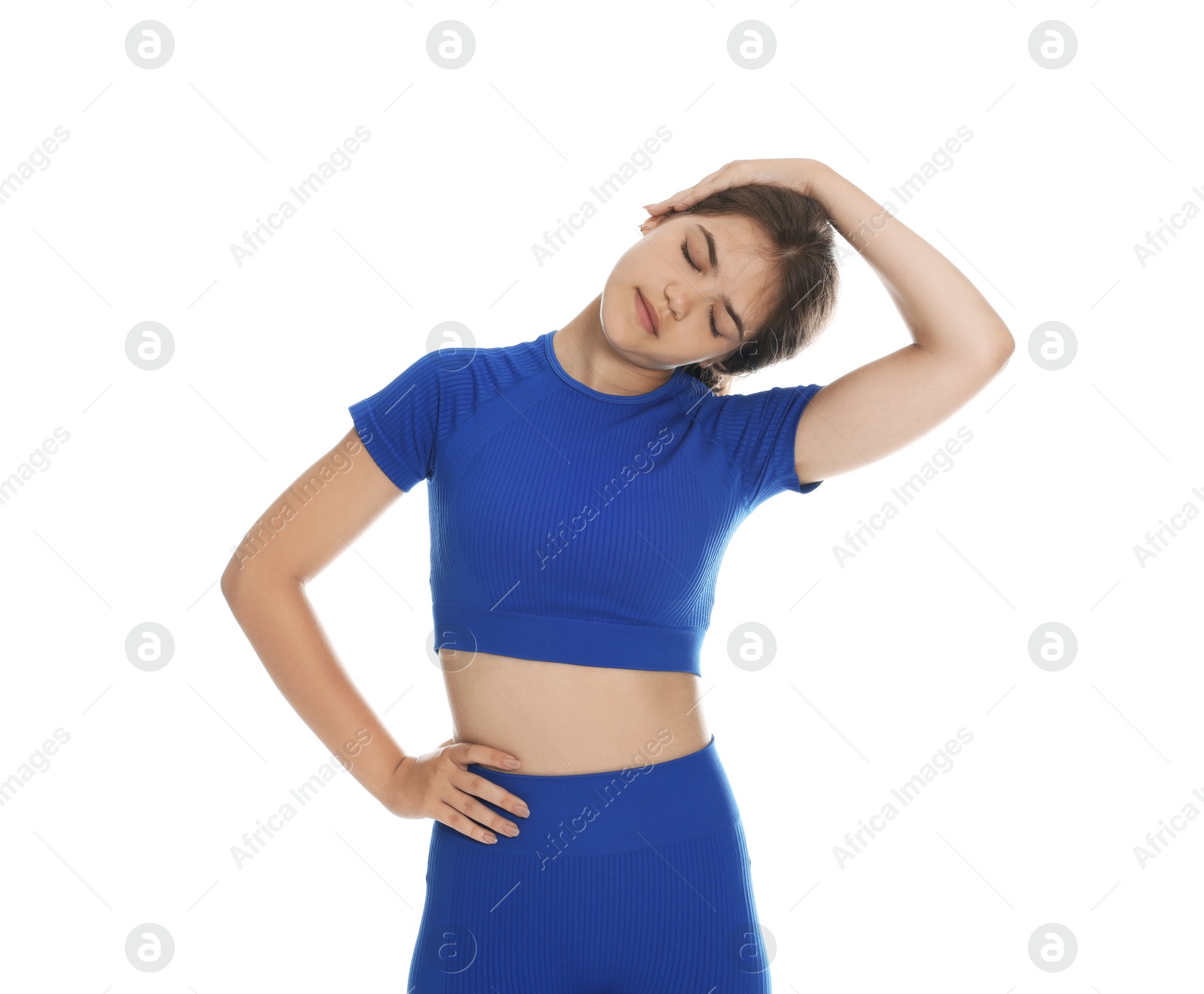 Teenage girl in sportswear stretching on white background Photo of Teenage girl in sportswear stretching on white background