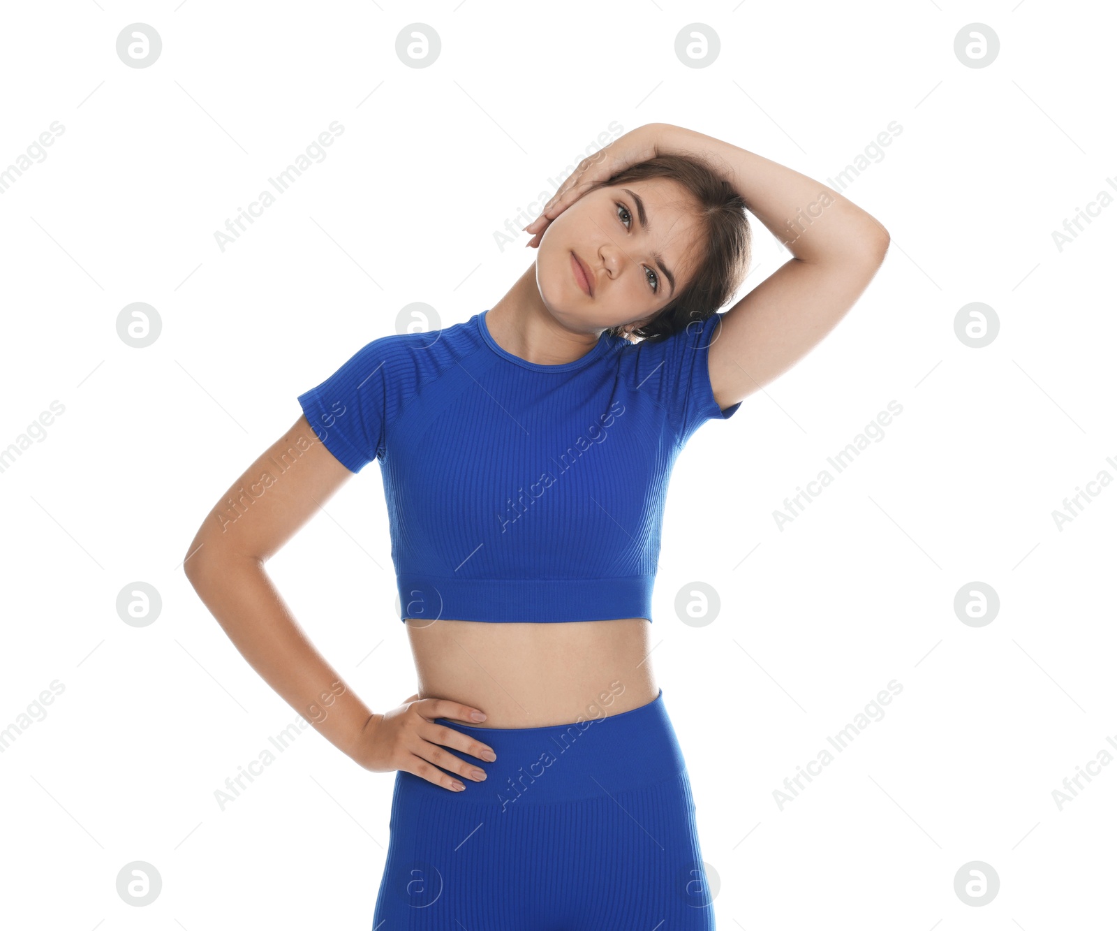 Teenage girl in sportswear stretching on white background Photo of Teenage girl in sportswear stretching on white background