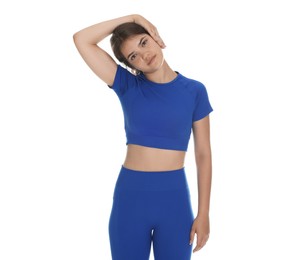 Photo of Teenage girl in sportswear stretching on white background