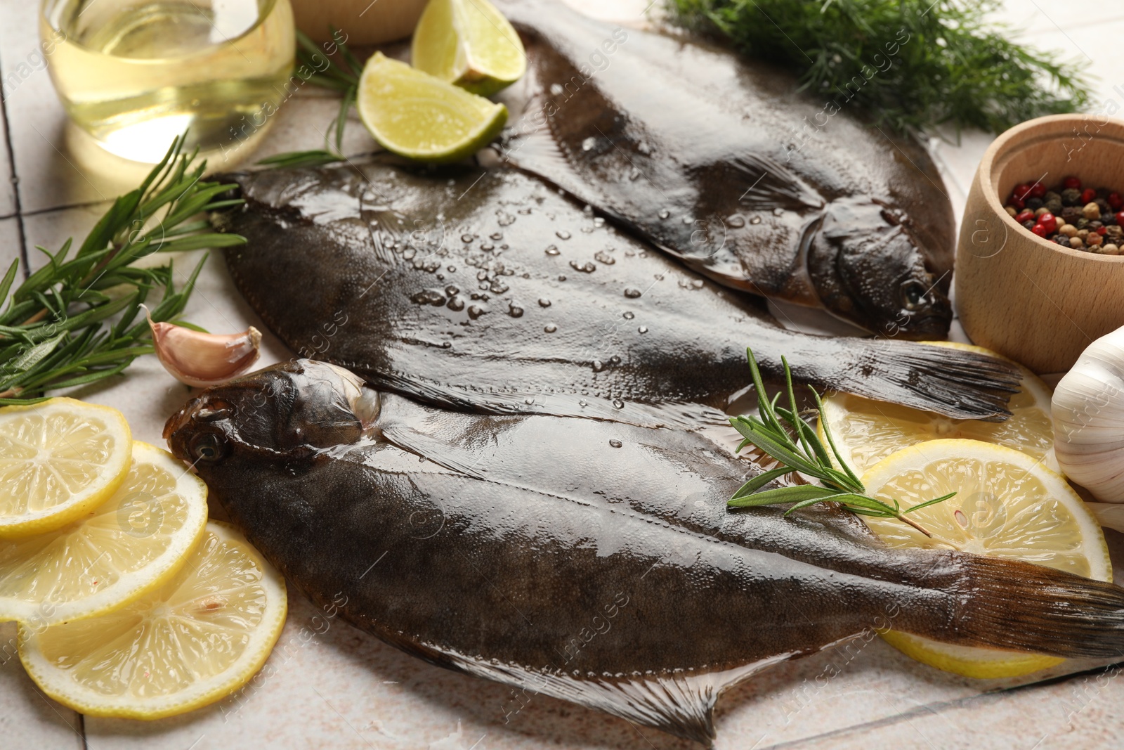 Fresh raw flounder fish and spices on light tiled table, closeup. Seafood Photo of Fresh raw flounder fish and spices on light tiled table, closeup. Seafood