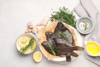 Photo of Fresh raw flounder fish and spices on light grey table, flat lay. Seafood