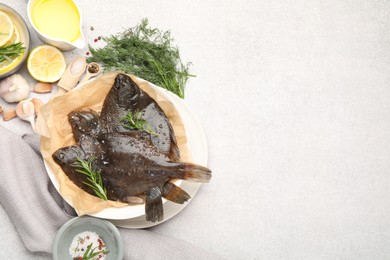 Photo of Seafood. Fresh raw flounder fish and spices on light grey table, flat lay. Space for text
